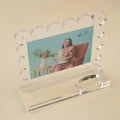 Nora Fleming clearly a-nora-ble: scalloped acrylic frame.